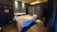 a bedroom with a large bed and a large window at Yomi Hotel - ShuangLian MRT in Taipei