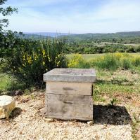 a wooden box sitting on top of a field at chambre d&#39;hôtes Et Puis Voilà! in Murs