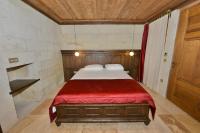 A bed or beds in a room at Evanthia Cave Suites