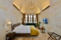 A bed or beds in a room at Evanthia Cave Suites