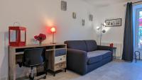 a living room with a couch and a desk and a chair at Le petit Moulin de la Motte in Bellenot-sous-Pouilly