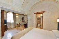 A bed or beds in a room at Evanthia Cave Suites