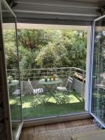 a view of a patio with a table and chairs at Résidence Océane Appartement Nature in Albi