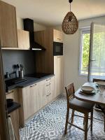 a kitchen with a table and a dining room at Résidence Océane Appartement Nature in Albi