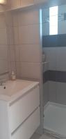 a white bathroom with a sink and a shower at Mas Vincent in La Fare-les-Oliviers