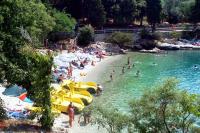 a beach with a bunch of people in the water at Apartments with a parking space Rabac, Labin - 7442 in Rabac