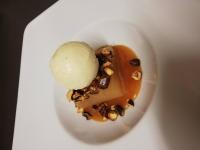 a white plate with a dessert with a scoop of ice cream at Logis Hôtel-Restaurant Les Airelles in Neufchâtel-en-Bray