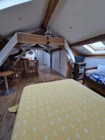 a bedroom with a bed in a room with wooden floors at La maison du vigneron in Auzon