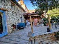 a wooden deck in front of a house at La maison du vigneron in Auzon