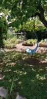 a blue swing in the middle of a park at L&#39;Orme Seul, Maison d&#39;hôtes in Vineuil
