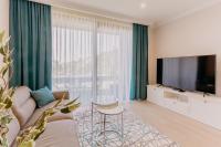 Televízia a/alebo spoločenská miestnosť v ubytovaní Carmen Residence Apartments