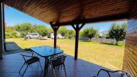 a patio with a table and chairs and a field at Casa Vio in Timişoara