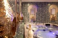 a bathroom with a tub and a tiled wall at La Casa dei Sogni in Flayosc