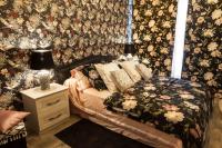 a bedroom with a bed with a floral wallpaper at La Casa dei Sogni in Flayosc