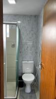 a bathroom with a toilet and a glass shower at Residencial Havaí in João Pessoa
