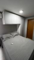 a bedroom with a large bed with a cabinet above it at Residencial Havaí in João Pessoa