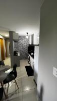 a kitchen with a table and a stove and a table and chairs at Residencial Havaí in João Pessoa