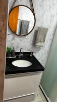 a bathroom with a sink and a mirror at Residencial Havaí in João Pessoa
