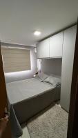 a small bedroom with a bed and white cabinets at Residencial Havaí in João Pessoa