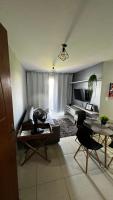 a living room with a couch and a table at Residencial Havaí in João Pessoa