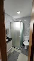 a bathroom with a toilet and a glass shower at Residencial Havaí in João Pessoa