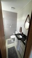 a bathroom with a sink and a toilet at Residencial Havaí in João Pessoa
