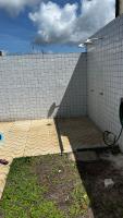 a tiled wall with a wooden floor in front at Residencial Havaí in João Pessoa