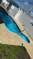 a large blue swimming pool with a hose around it at Residencial Havaí in João Pessoa