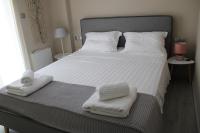 A bed or beds in a room at Urban Chic Apartments Lefkada