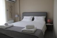 A bed or beds in a room at Urban Chic Apartments Lefkada