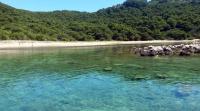 a body of water with a beach and trees at Seaside secluded apartments Cove Blaca, Mljet - 615 in Saplunara