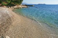 a rocky beach with a train in the water at Apartments with a parking space Orebic, Peljesac - 15086 in Orebić