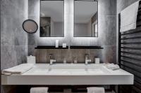 a bathroom with a large white sink and mirrors at Fleur de Loire in Blois