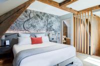 a bedroom with a large white bed and a wall mural at Fleur de Loire in Blois
