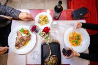 a group of people sitting at a table with plates of food at Etrusco Arezzo Hotel - Sure Hotel Collection by Best Western in Arezzo