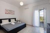 a bedroom with a bed and a large window at Vita Residence, a Charming Family Escape,By ThinkVilla in Pangalochori