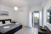 a bedroom with a bed and a view of the ocean at Vita Residence, a Charming Family Escape,By ThinkVilla in Pangalochori