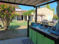 a patio with a sink and a table in a yard at Chambres d&#39;hôtes &amp; jacuzzi - A l&#39;ombre des amandiers in Saint-Martin-dʼArdèche