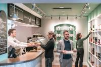 a group of people ordering food in a store at Monastère des Augustines in Quebec City