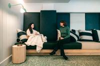 two women sitting on a couch in a room at Monastère des Augustines in Quebec City