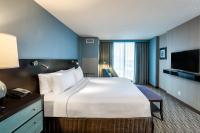 a hotel room with a large bed and a television at Crowne Plaza Chicago O'Hare Hotel & Conference Center by IHG in Rosemont