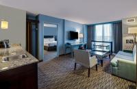 a hotel room with a bed and a living room at Crowne Plaza Chicago O'Hare Hotel & Conference Center by IHG in Rosemont