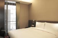 a bedroom with a white bed and a window at Capital Hotel SongShan in Taipei