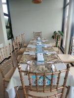 a long table with chairs and a laptop on it at GHIELLANIQA INN in San Nicolas