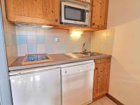 a small kitchen with a sink and a microwave at Appartement La Tania, 2 pièces, 4 personnes - FR-1-182A-6 in Courchevel