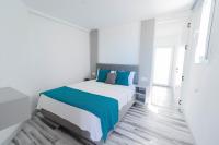 A bed or beds in a room at La Brezza Suite & Hotel