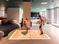 two children playing on a tennis court in a room at Falkensteiner Family Hotel Diadora in Zadar