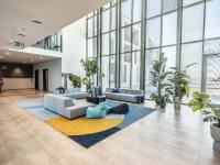 an office lobby with a lot of plants at Falkensteiner Family Hotel Diadora in Zadar