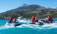 a group of people riding on rafts in the water at Appartement 2 chambres vue pistes, parking privatif in Les Orres