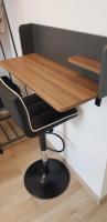 a wooden desk with a black chair underneath it at Escapade Niortaise - Studios climatisés hyper-centre de Niort in Niort